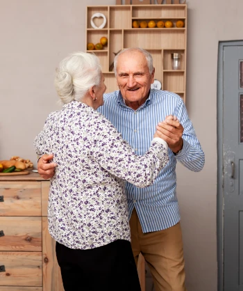 Elderly couple dancing & enjoying life. 